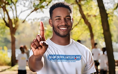 A volunteer holding up 1 finger